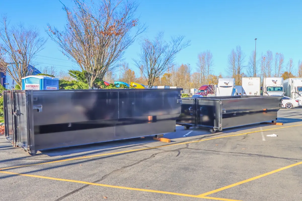 Professional dumpster rental service with roll-off container on residential driveway in New River